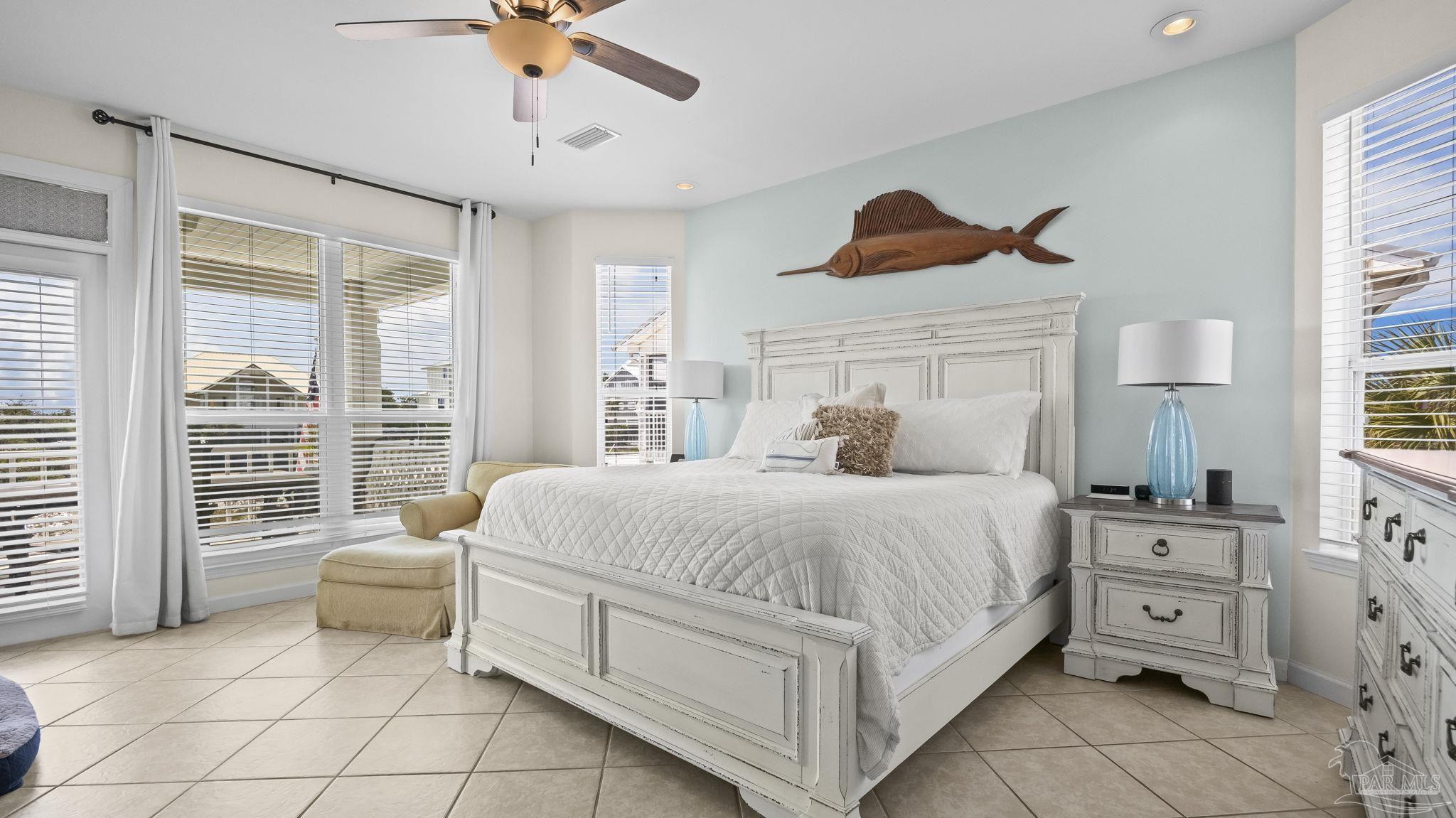 32580 Sandpiper Drive Orange Beach, AL 36561 - Photo 17 of 52 a spacious bedroom with a bed and a chandelier