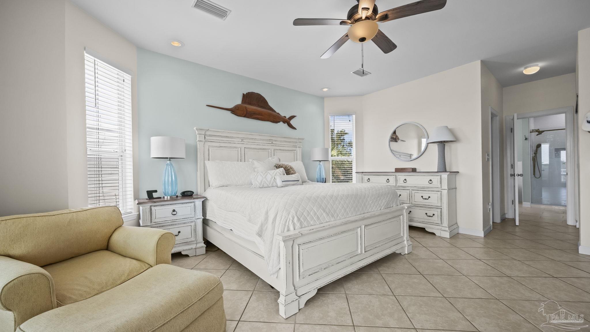 32580 Sandpiper Drive Orange Beach, AL 36561 - Photo 18 of 52 a bedroom with a bed and ceiling fan