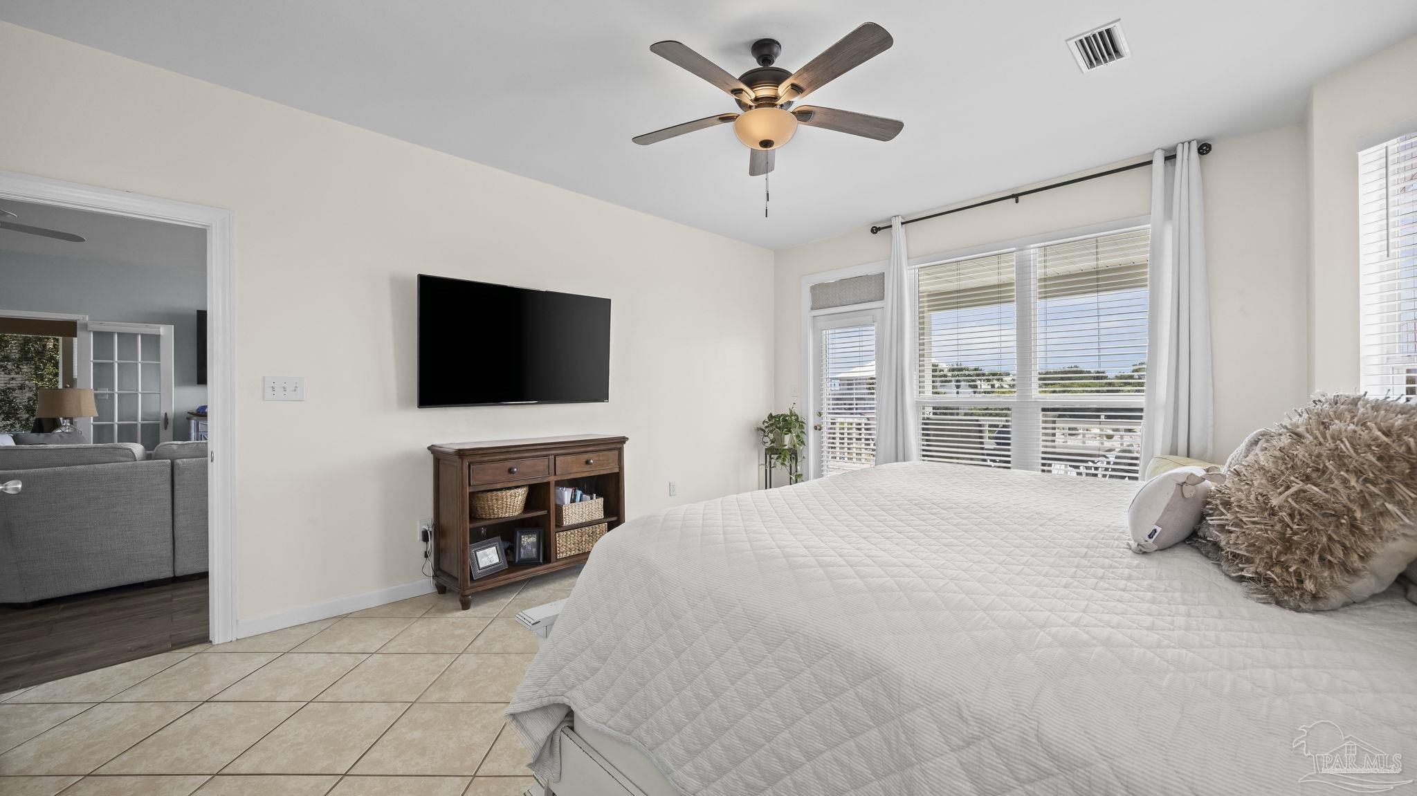 32580 Sandpiper Drive Orange Beach, AL 36561 - Photo 19 of 52 a bedroom with a bed and a flat screen tv