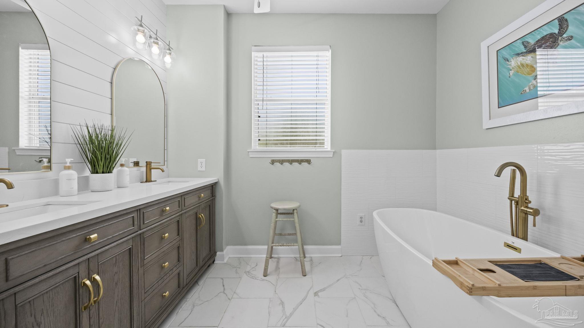32580 Sandpiper Drive Orange Beach, AL 36561 - Photo 20 of 52 a bathroom with a double vanity sink and a bathtub