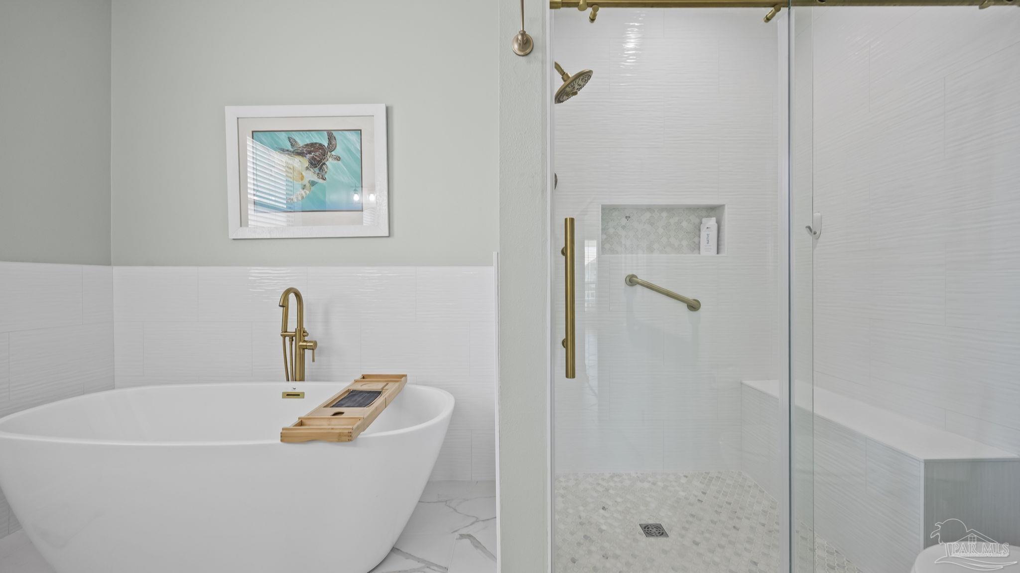 32580 Sandpiper Drive Orange Beach, AL 36561 - Photo 21 of 52 a white bath tub sitting next to a bathroom