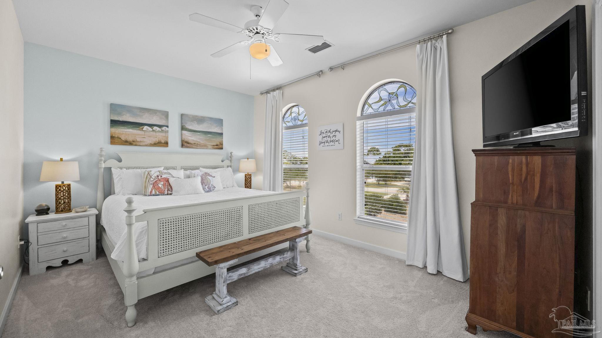 32580 Sandpiper Drive Orange Beach, AL 36561 - Photo 24 of 52 a bedroom with a bed and a flat tv screen on dresser