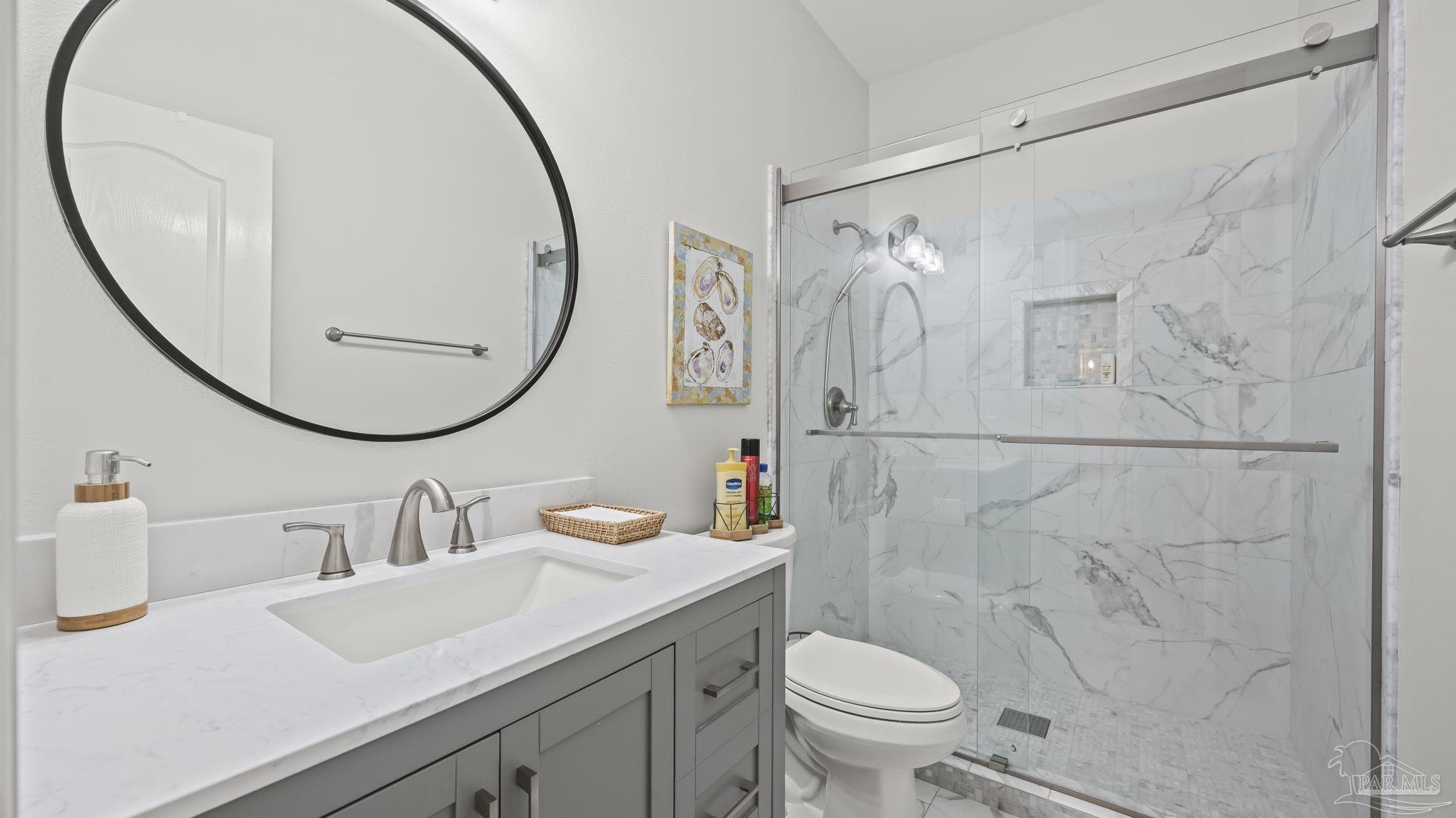 32580 Sandpiper Drive Orange Beach, AL 36561 - Photo 25 of 52 a bathroom with a sink a toilet and a mirror