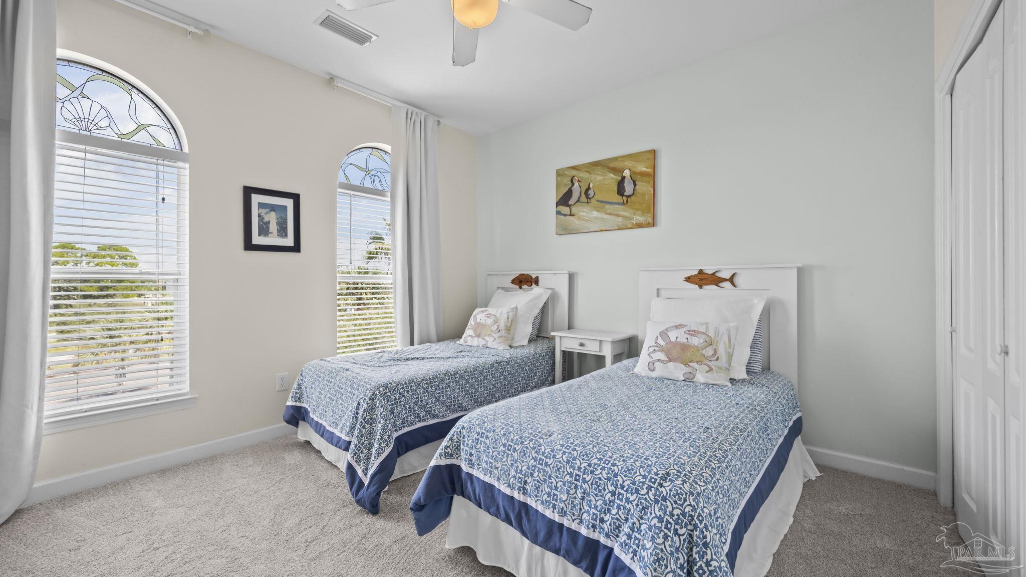 32580 Sandpiper Drive Orange Beach, AL 36561 - Photo 26 of 52 a bedroom with two beds and a window