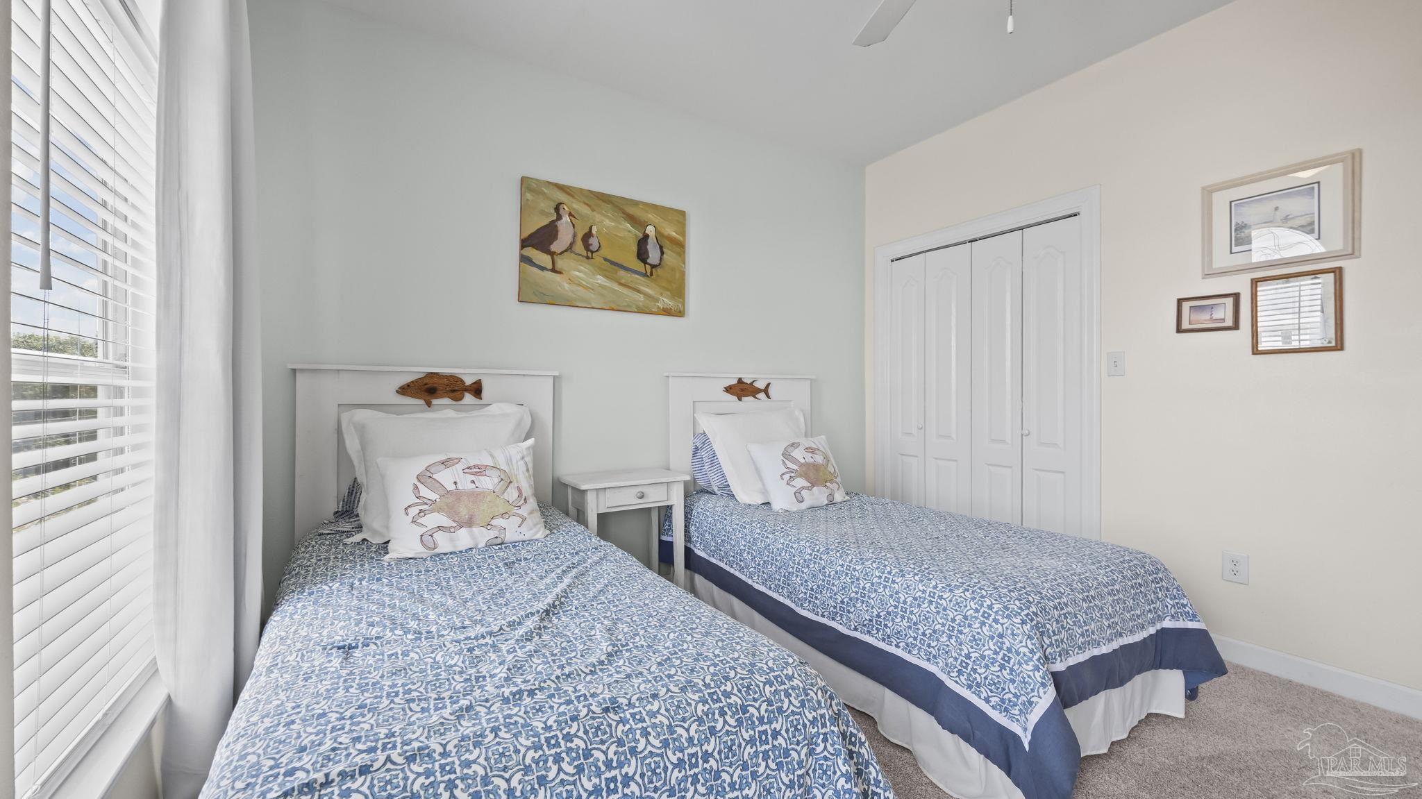 32580 Sandpiper Drive Orange Beach, AL 36561 - Photo 27 of 52 a bedroom with a bed and wooden floor