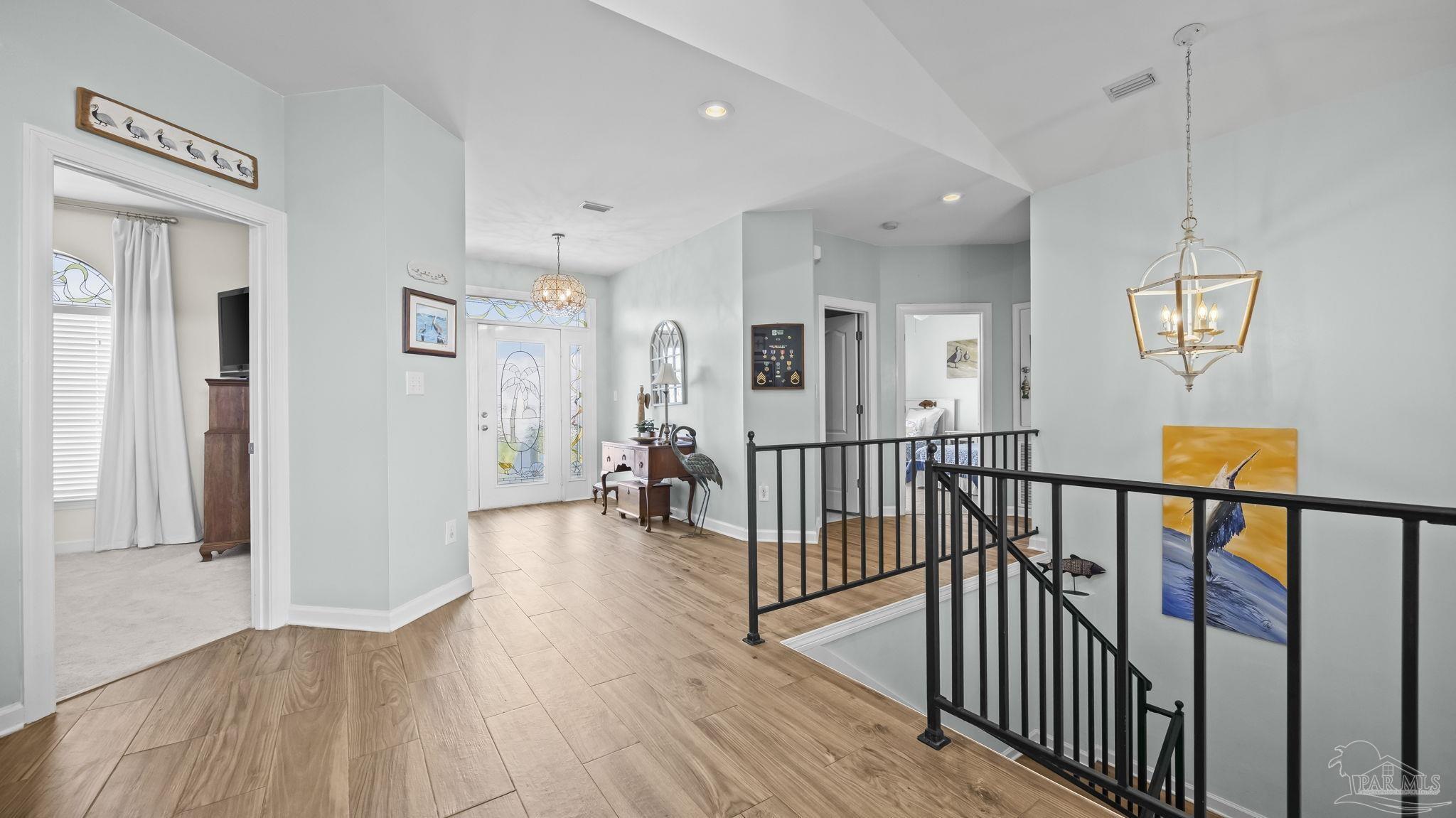 32580 Sandpiper Drive Orange Beach, AL 36561 - Photo 29 of 52 a view of a hallway with wooden floor and windows