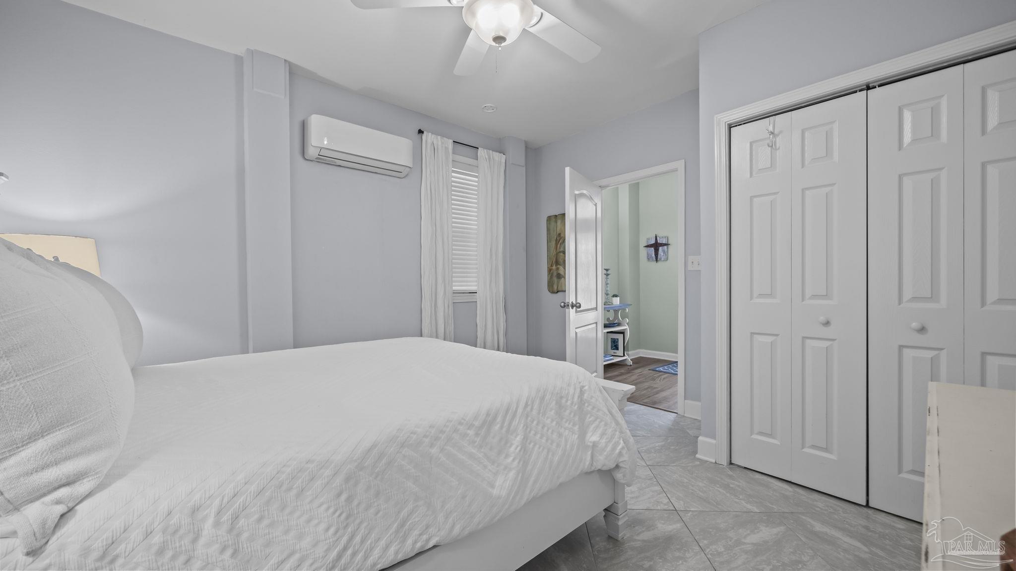 32580 Sandpiper Drive Orange Beach, AL 36561 - Photo 31 of 52 a bedroom with a bed and a chandelier