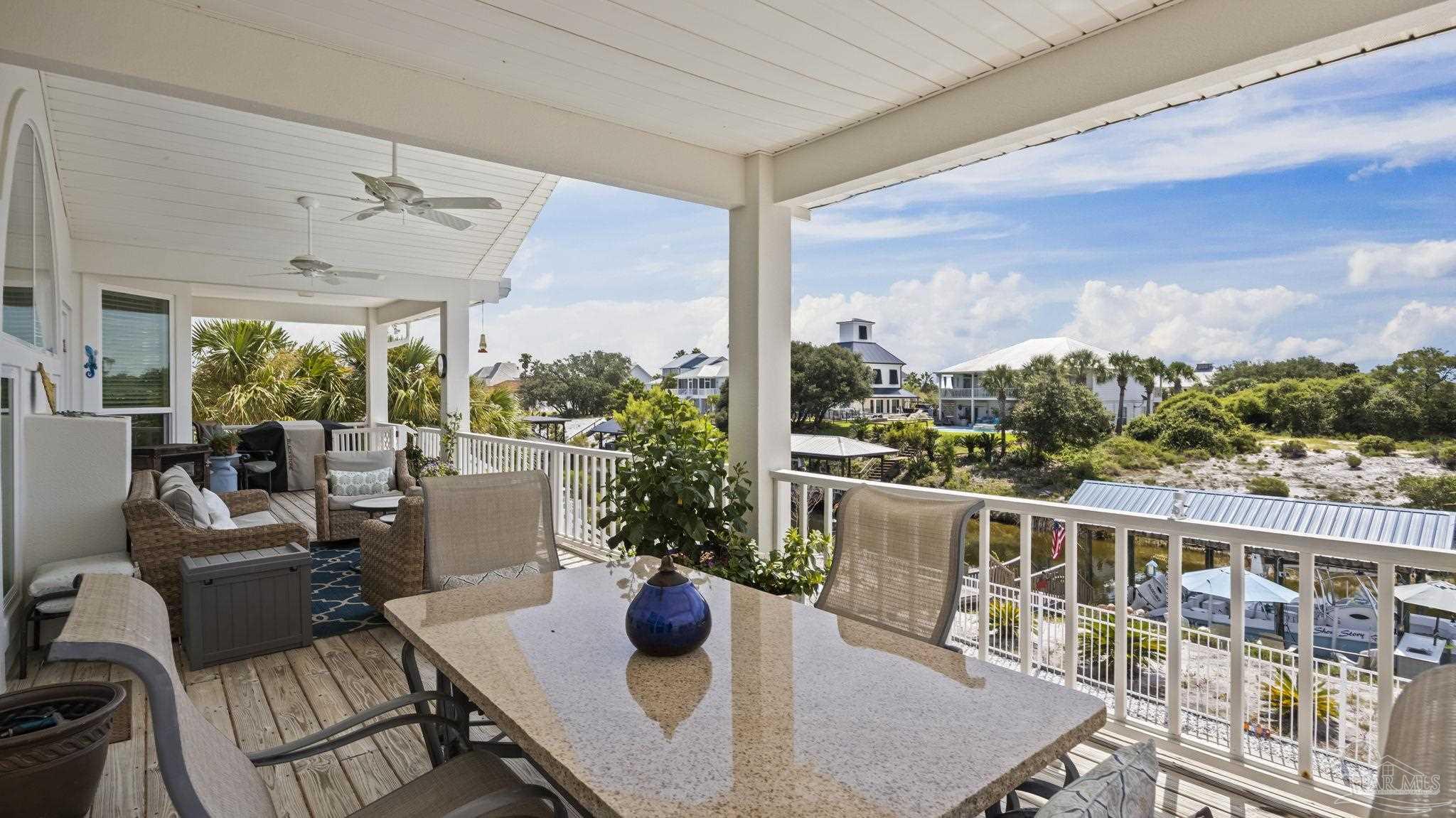 32580 Sandpiper Drive Orange Beach, AL 36561 - Photo 34 of 52 a view of a patio with couches chairs potted plants and city view