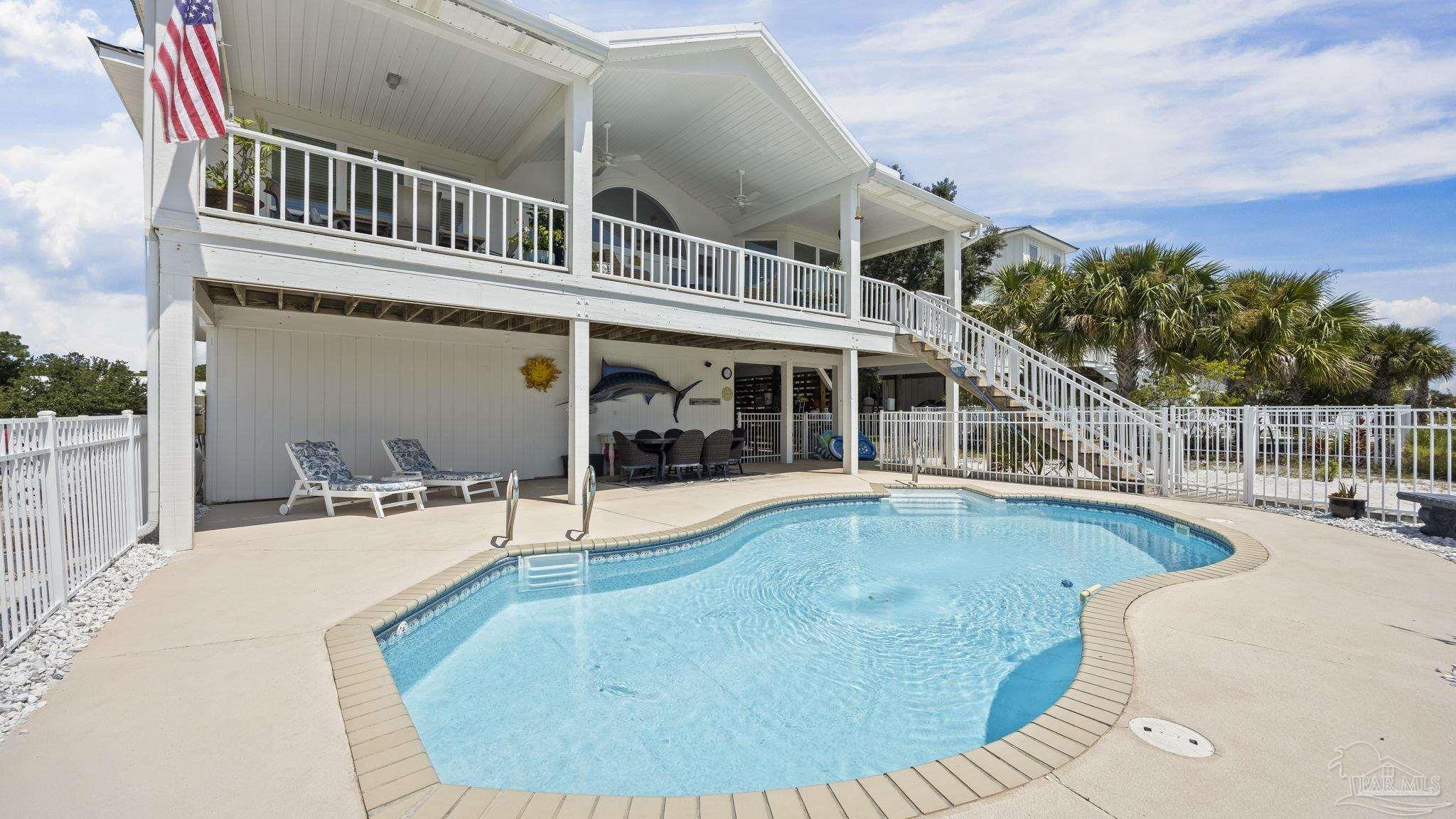 32580 Sandpiper Drive Orange Beach, AL 36561 - Photo 36 of 52 a swimming pool with outdoor seating