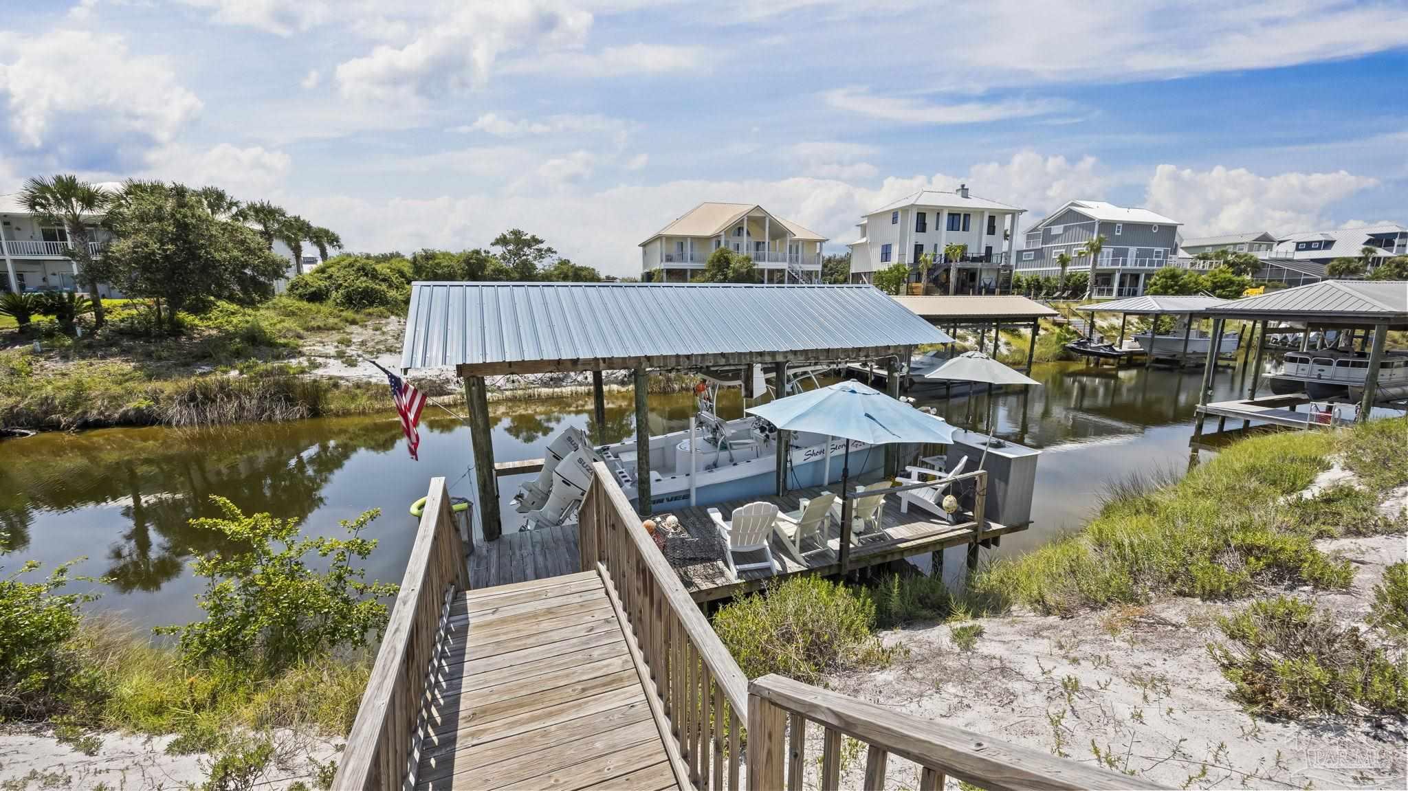 32580 Sandpiper Drive Orange Beach, AL 36561 - Photo 37 of 52 a view of a roof deck with chair and a lake view
