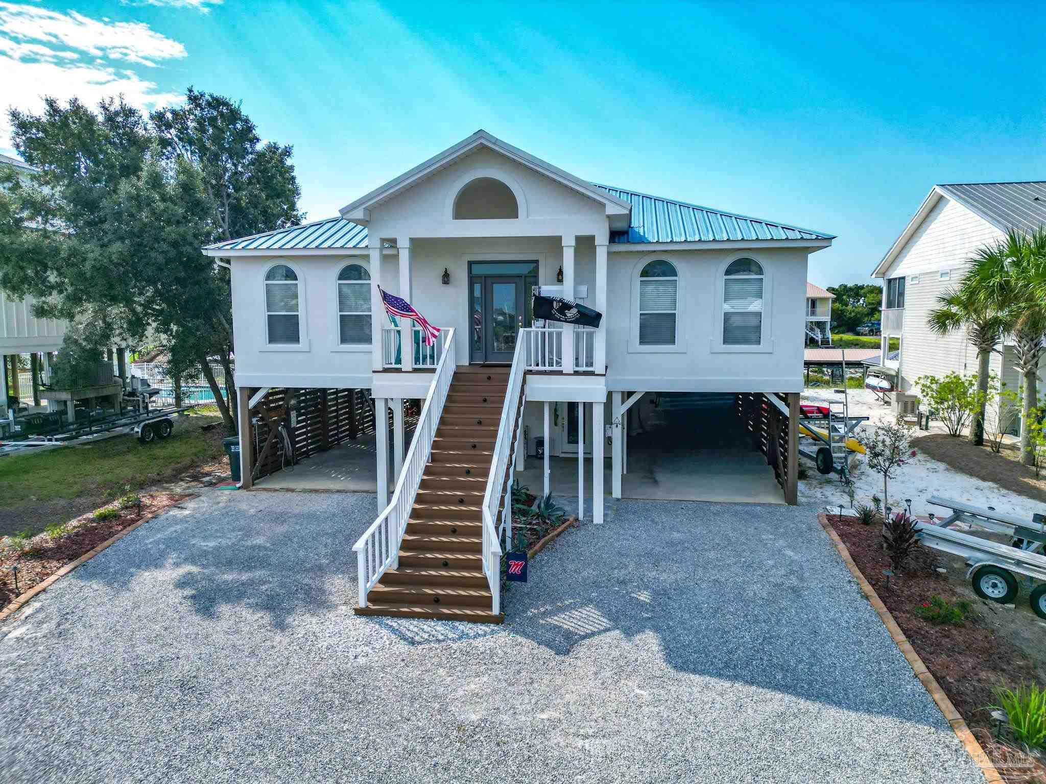 32580 Sandpiper Drive Orange Beach, AL 36561 - Photo 43 of 52 a view of a house with a yard and deck