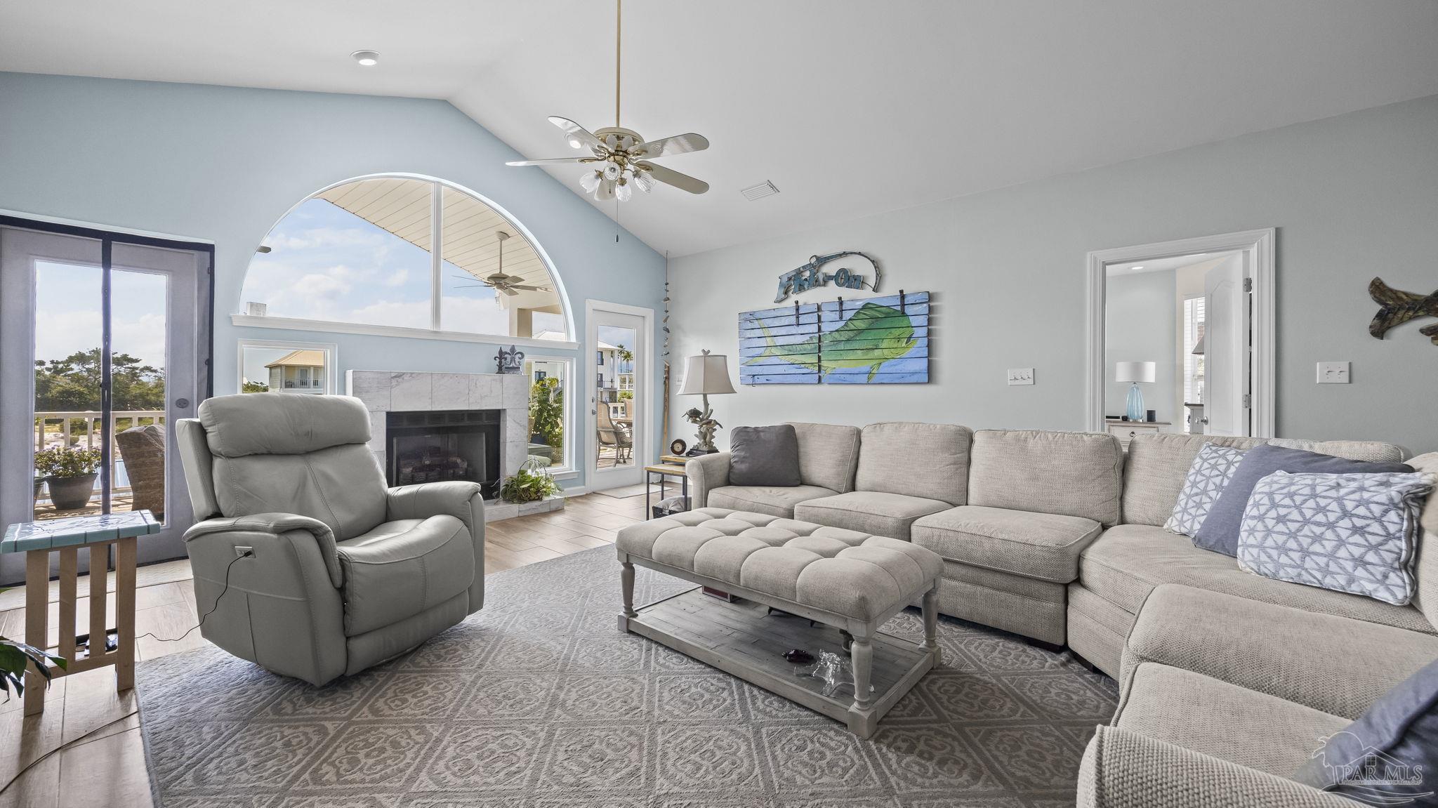32580 Sandpiper Drive Orange Beach, AL 36561 - Photo 8 of 52 a living room with furniture a fireplace and a large window