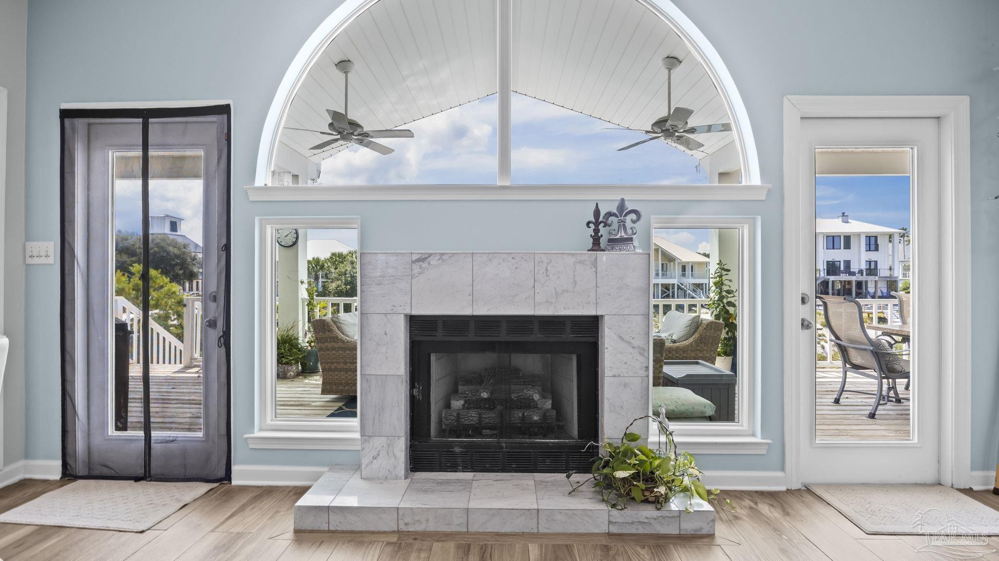 32580 Sandpiper Drive Orange Beach, AL 36561 - Photo 10 of 52 a living room with a fireplace and a wooden floor