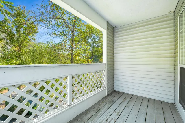 a balcony with wooden floor and outdoor space