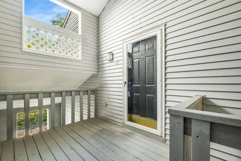 a view of a balcony with wooden floor