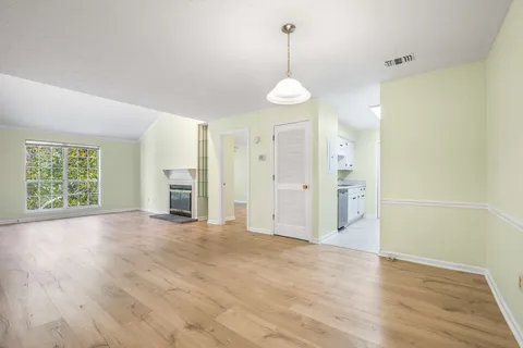 a view of a livingroom with wooden floor and window