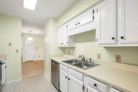a kitchen with stainless steel appliances white cabinets and a sink
