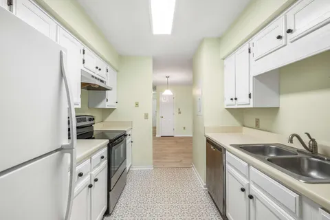 a kitchen with granite countertop a sink and cabinets