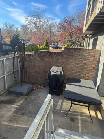 a balcony with table and chairs