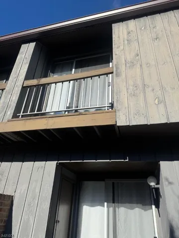 a living room with furniture and a gym machine