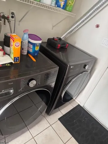 a kitchen with white cabinets and appliances