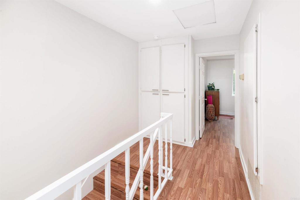 4239 Vista Del Rio Way, Unit 6 Oceanside, CA 92057 - Photo 17 of 30 a view of a hallway with wooden floor and staircase