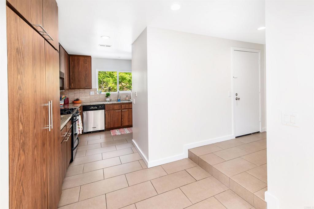4239 Vista Del Rio Way, Unit 6 Oceanside, CA 92057 - Photo 6 of 30 a kitchen with stainless steel appliances granite countertop a refrigerator and a stove