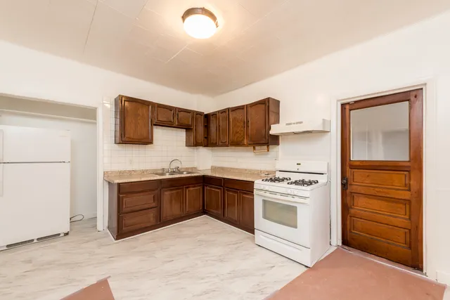 a kitchen with stainless steel appliances granite countertop a stove and a refrigerator