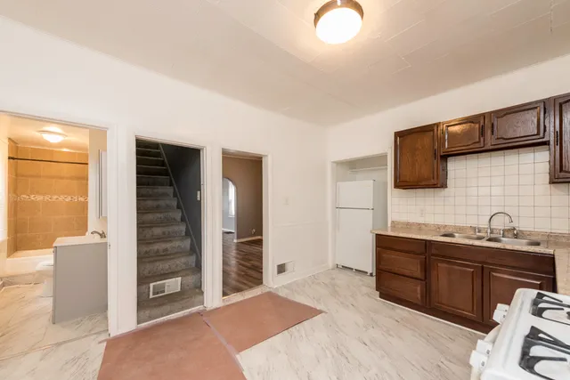 a spacious bathroom with a granite countertop sink and a mirror