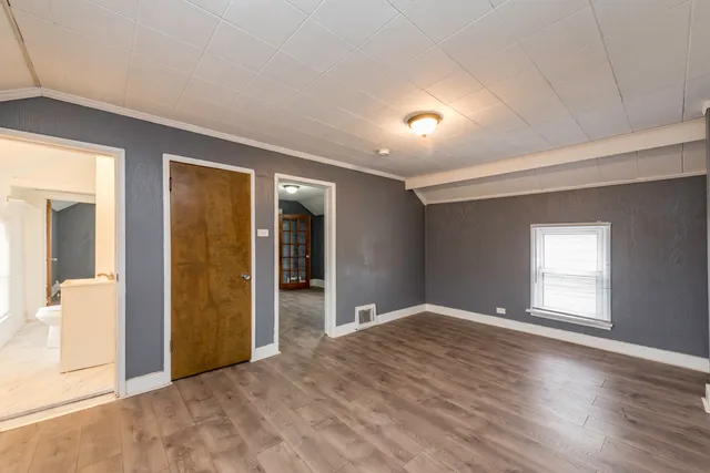 an empty room with windows and closet