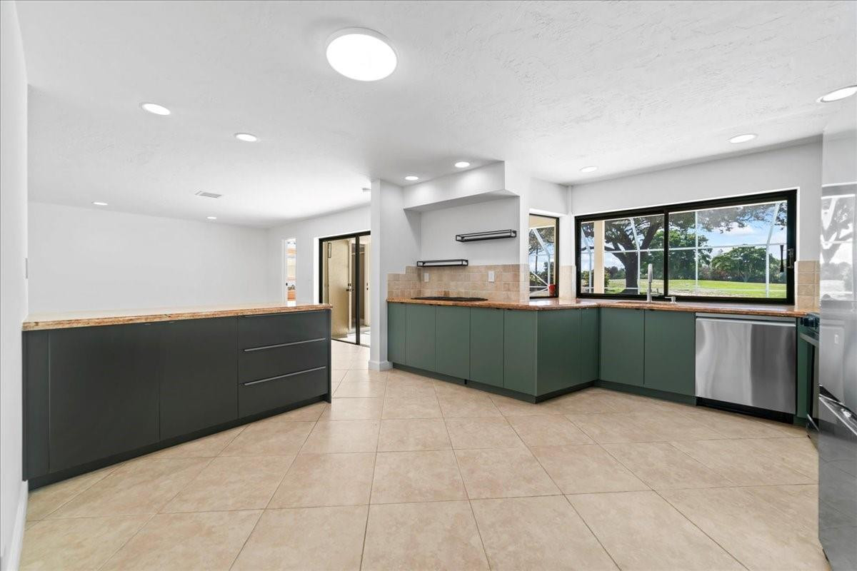 8600 Gatehouse Road Plantation, FL 33324 - Photo 13 of 27 a kitchen with stainless steel appliances kitchen island granite countertop a refrigerator and a sink