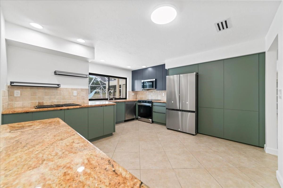 8600 Gatehouse Road Plantation, FL 33324 - Photo 10 of 27 a kitchen with a refrigerator and a sink