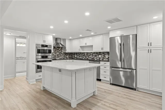 a bathroom with a granite countertop sink a toilet a mirror a vanity and shower