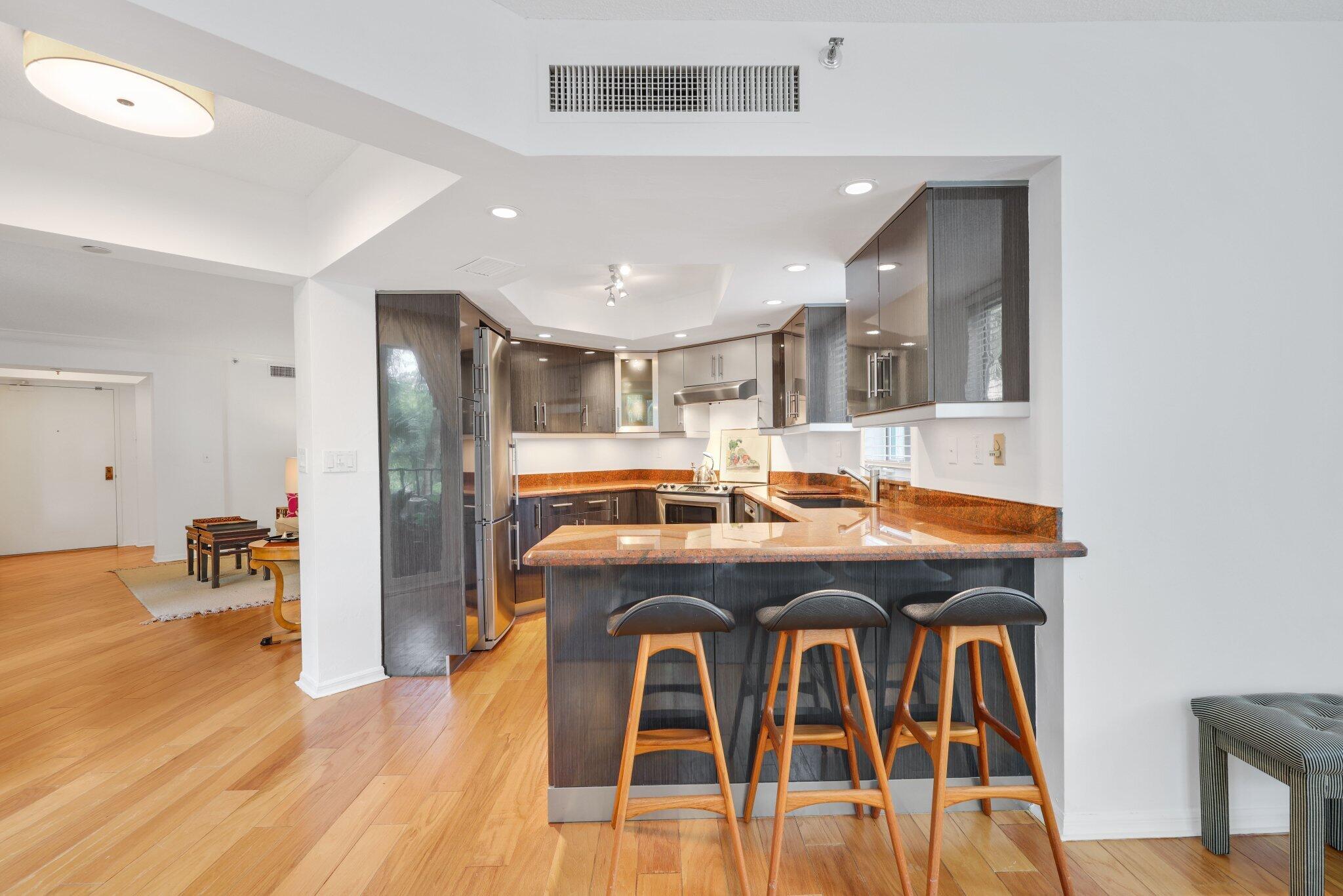 100 Southeast 5th Avenue, Unit 308 Boca Raton, FL 33432 - Photo 22 of 49 a view of a dining room with furniture and wooden floor