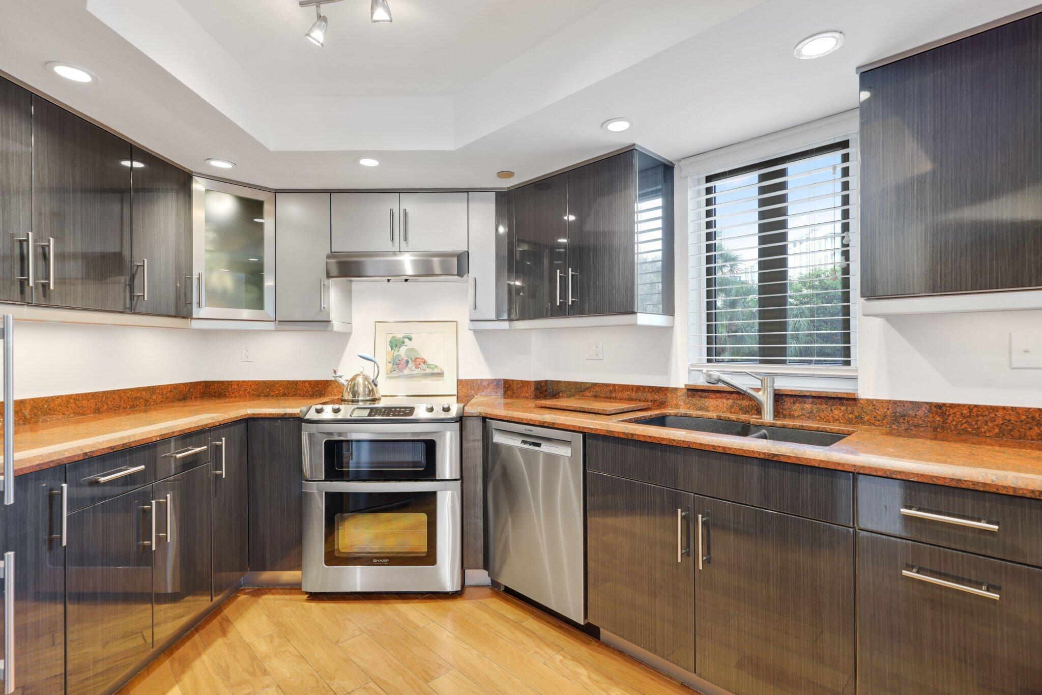 100 Southeast 5th Avenue, Unit 308 Boca Raton, FL 33432 - Photo 24 of 49 a kitchen with stainless steel appliances granite countertop a sink and a stove