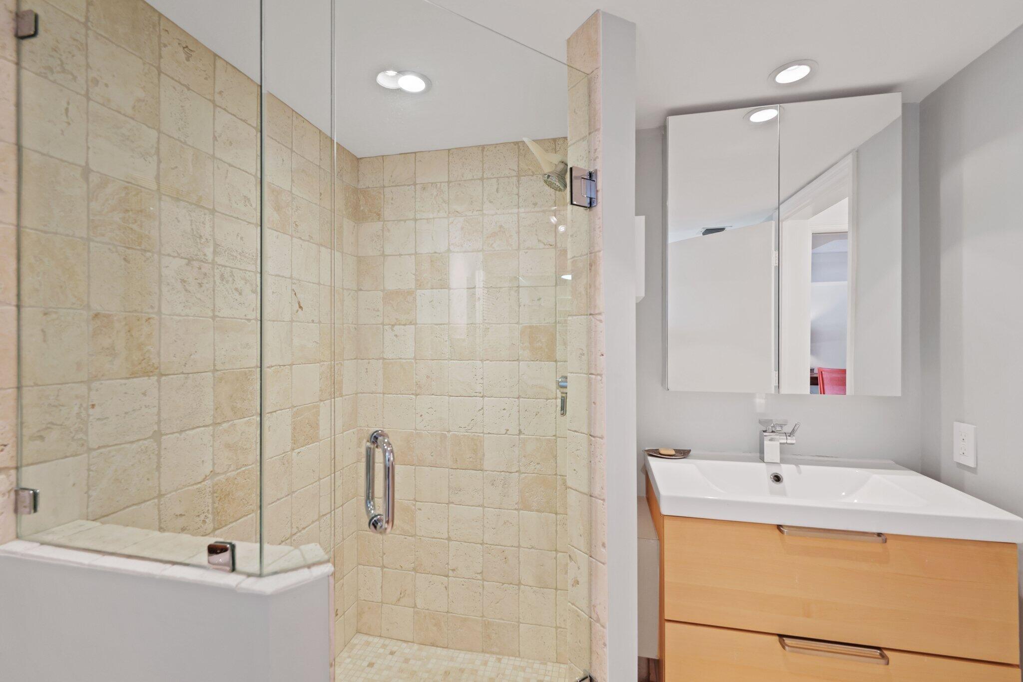 100 Southeast 5th Avenue, Unit 308 Boca Raton, FL 33432 - Photo 44 of 49 a bathroom with a granite countertop sink a toilet and shower