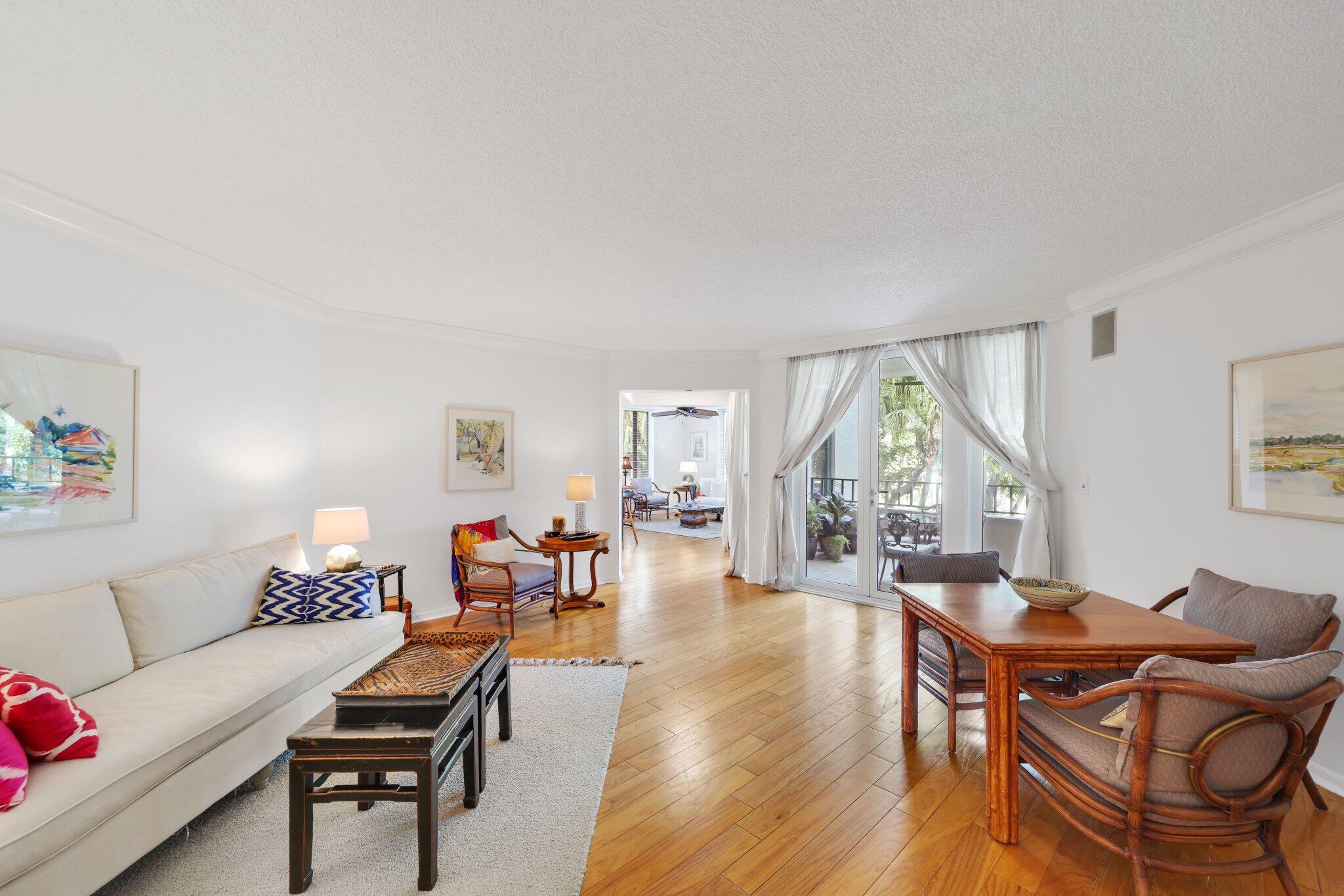 100 Southeast 5th Avenue, Unit 308 Boca Raton, FL 33432 - Photo 10 of 49 a living room with furniture a wooden floor and a large window