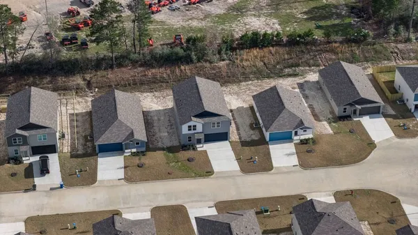 an aerial view of houses with outdoor space