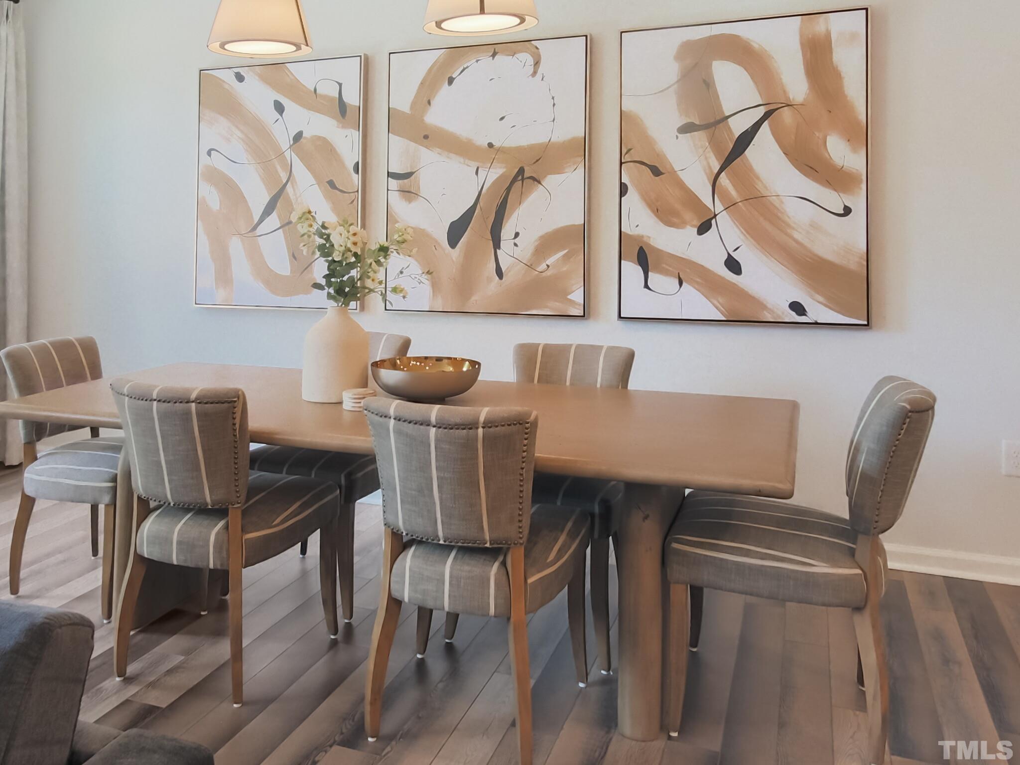 1622 Emory Ridge Way, Unit 22 Wake Forest, NC 27587 - Photo 11 of 24 a view of a dining room with furniture and wooden floor