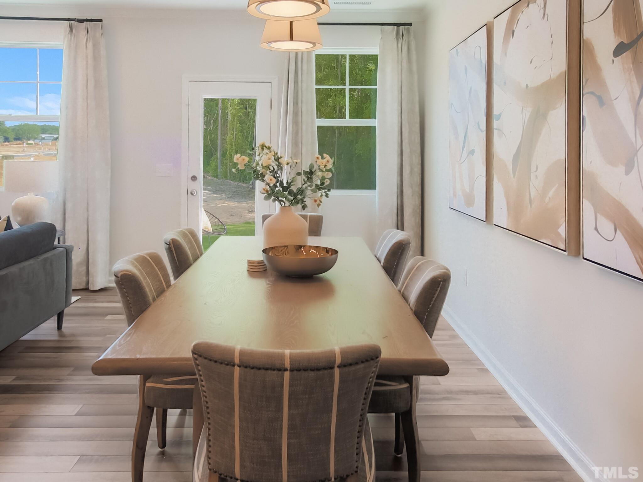 1622 Emory Ridge Way, Unit 22 Wake Forest, NC 27587 - Photo 10 of 24 a view of a dining room with furniture and wooden floor