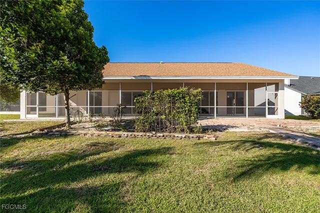 a view of house with backyard