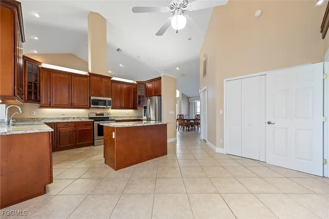 a large kitchen with a large counter top appliances and cabinets