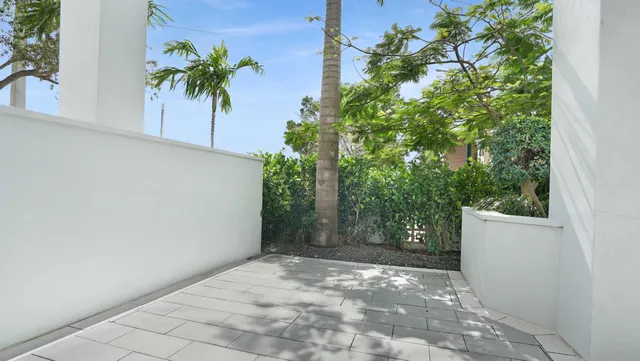 a view of a kitchen with kitchen island a sink and wooden floor