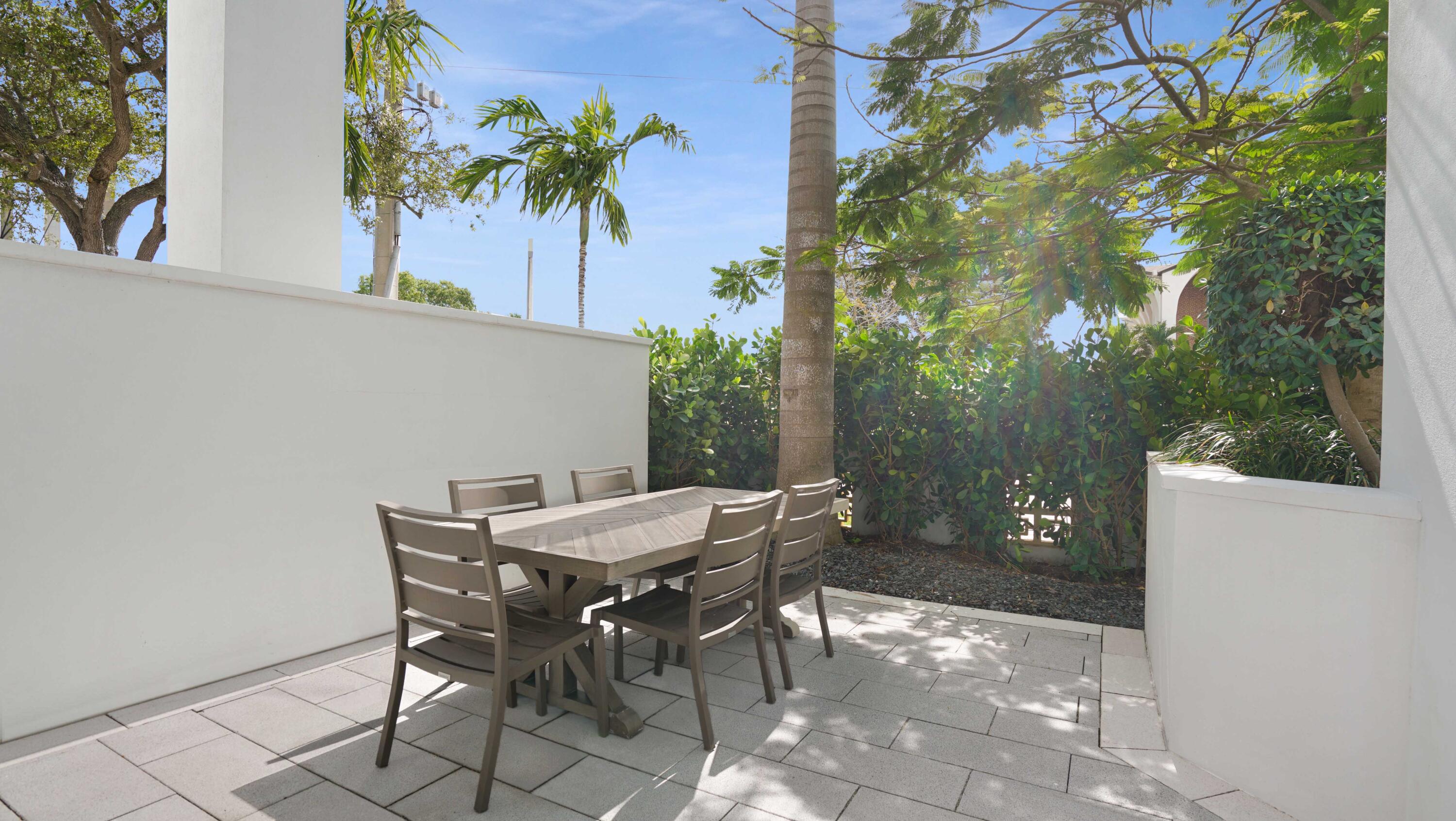 155 East Boca Raton Road, Unit TH3 Boca Raton, FL 33432 - Photo 111 of 112 a view of a backyard with a patio and outdoor seating