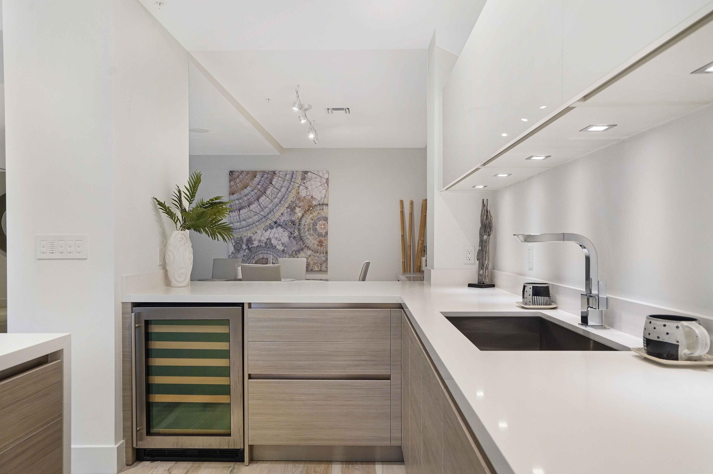 155 East Boca Raton Road, Unit TH3 Boca Raton, FL 33432 - Photo 36 of 112 a kitchen with a sink cabinets and a potted plant