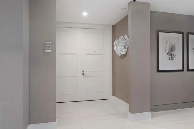 a view of entryway and hall with wooden floor