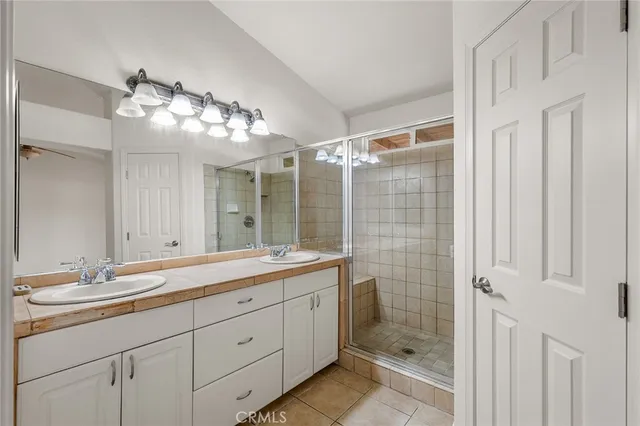 a bathroom with a double vanity sink and a mirror