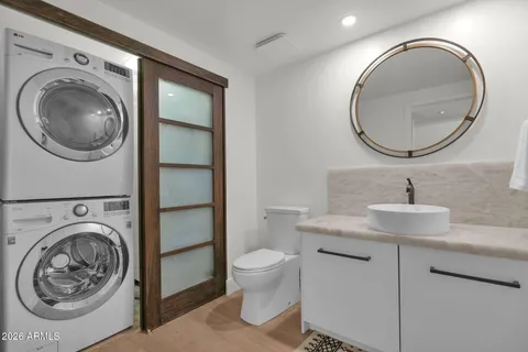 a bathroom with a toilet a sink and a mirror