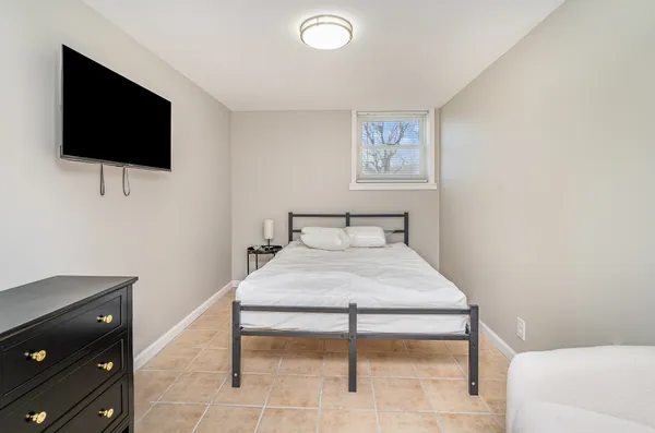 a bedroom with a bed and a flat screen tv