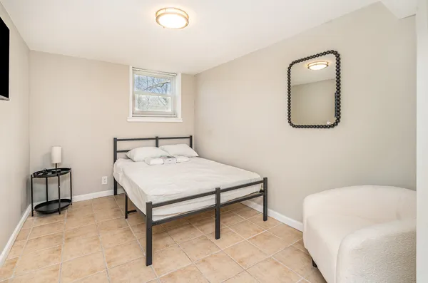 a bedroom with a bed and a mirror